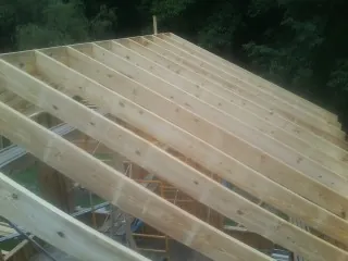 New roof rafters set over an addition before sheathing in Northbrook